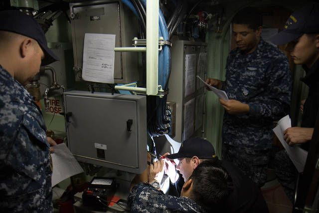 As-we-made-our-way-to-the-middle-level-we-ran-into-a-group-of-sailors-performing-a-preventative-maintenance-check-of-the-ships-electrical-components-.jpg